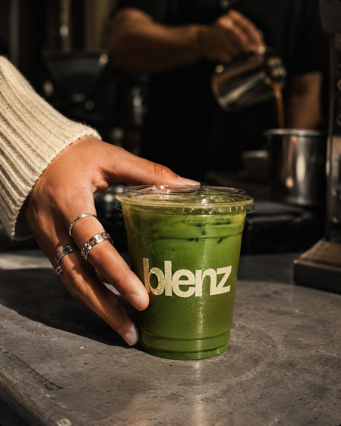Matcha iced latte hand reaching